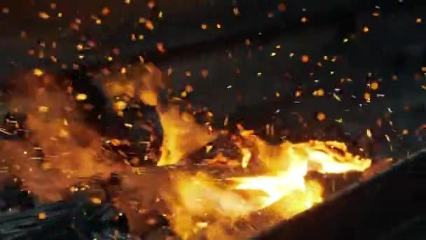 Closeup shot of fire sparks moving on dark at black background coming from brightly burning warm — Stock Video