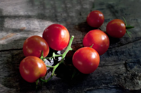 Fresh red tomatoes on dark wooden background — Stock Photo, Image