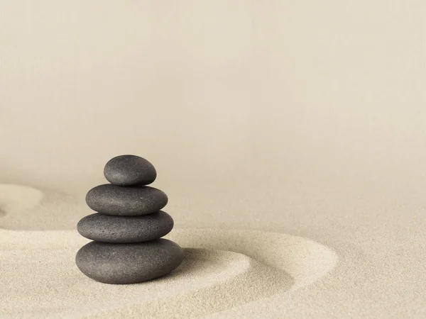 Dark black stones on sand — Stock Photo, Image