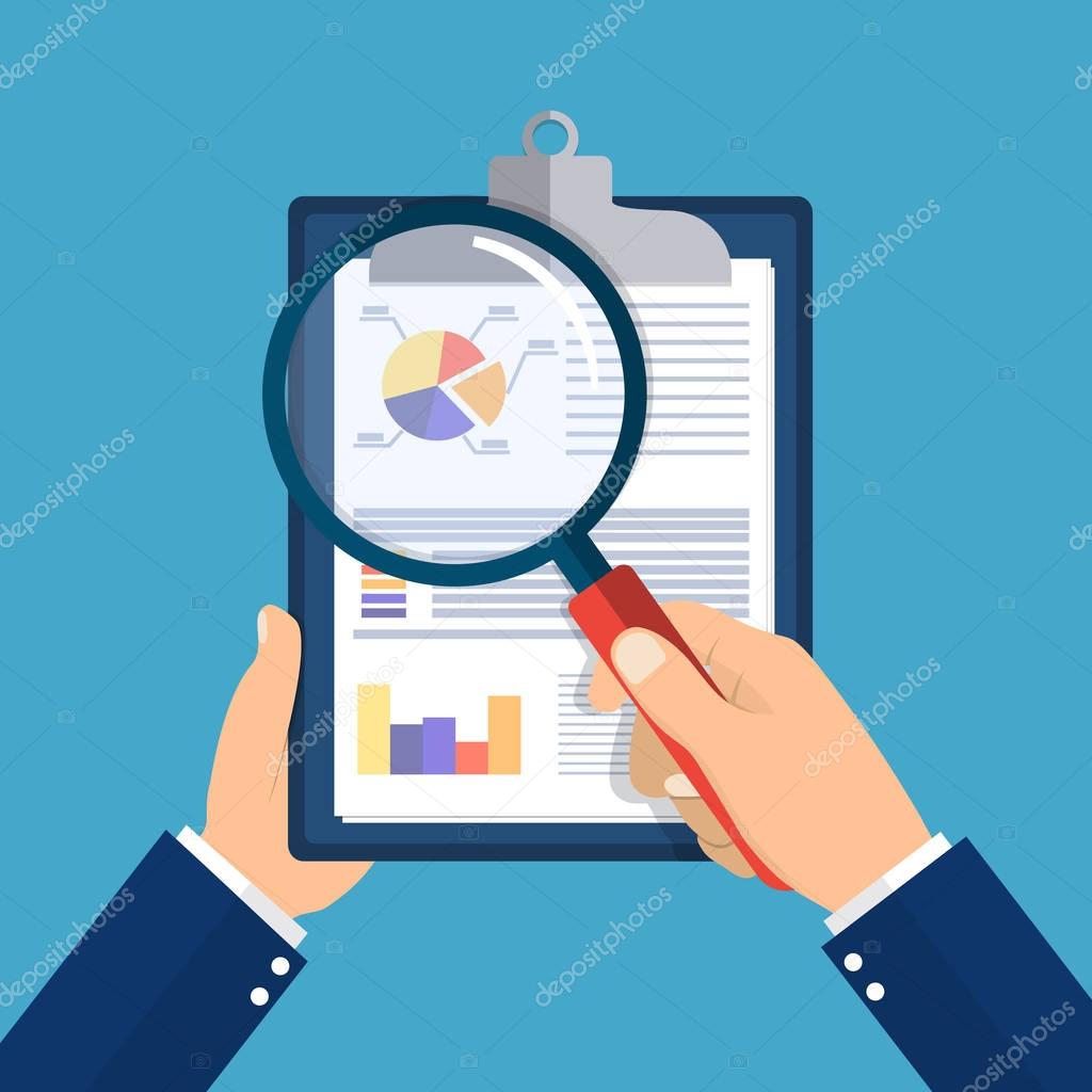 hand holding clipboard with financial reports