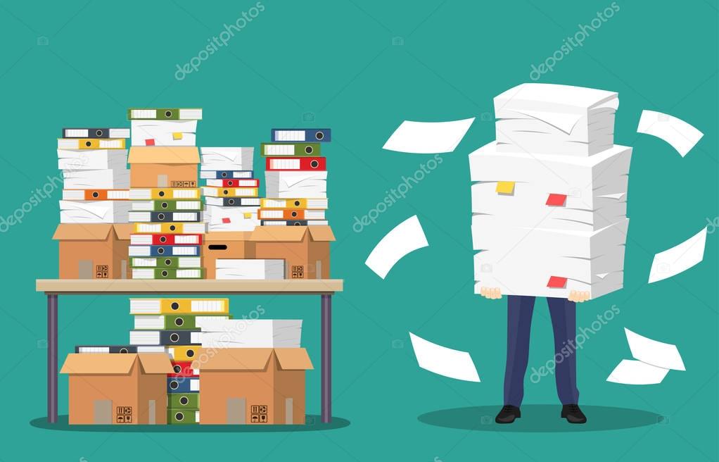 Businessman holds pile of office papers and documents.