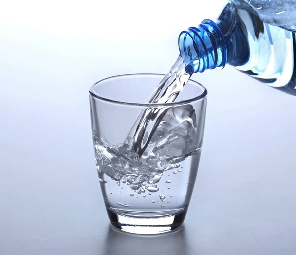 Water glass with bottle — Stock Photo, Image