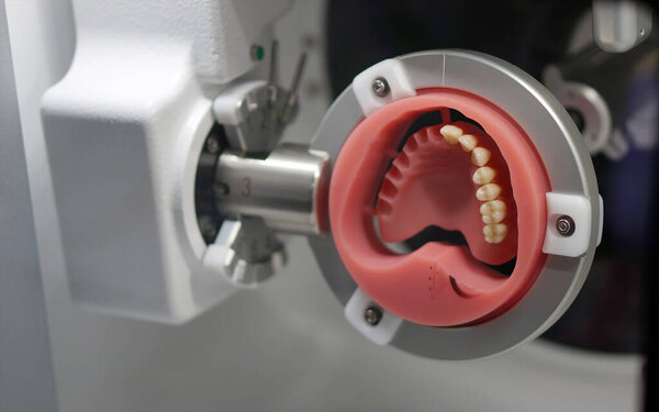 making of human dentures with machine in dentist clinic