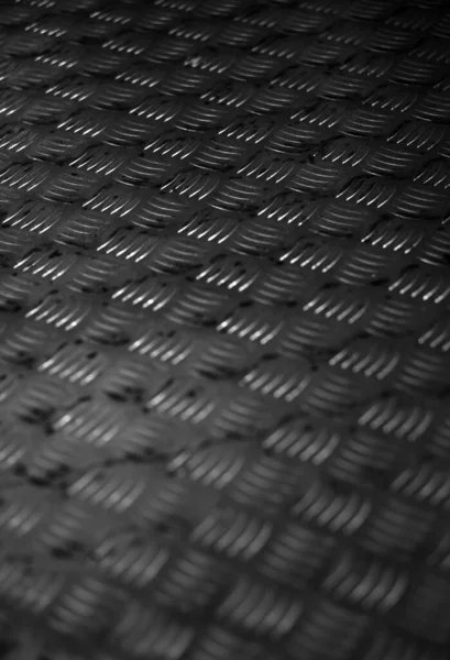 Closeup of Textured metal plate for flooring in Industrial background