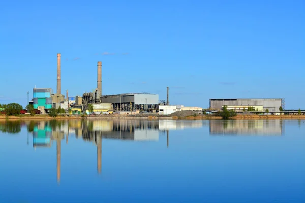 Cement factory reflected on water — Stock Photo, Image