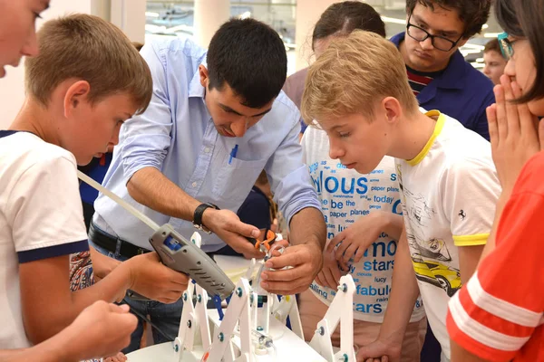 L "équipe de jeunes élèves discute de l" étape de la conception d'un robot — Photo