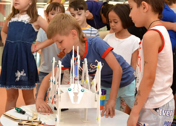 The team of junior schoolchildren discusses the stage of designing a robot — Stock Photo, Image