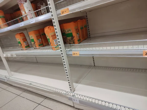 Empty shelves in a supermarket. Many shops are low on goods due to floods preventing deliveries and panic buying