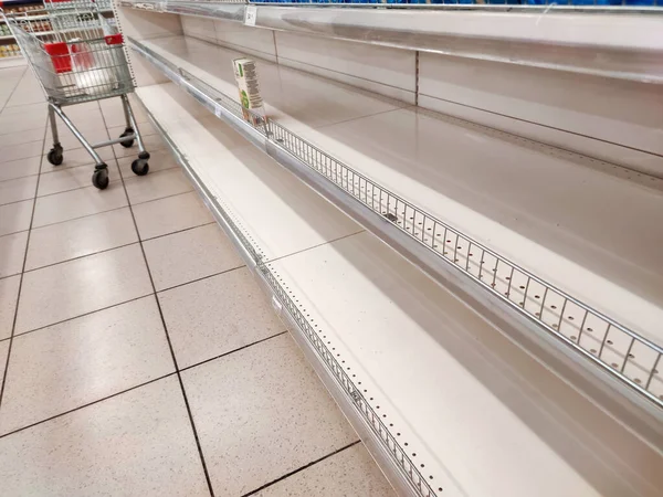 Empty shelves in a supermarket. Many shops are low on goods due to floods preventing deliveries and panic buying