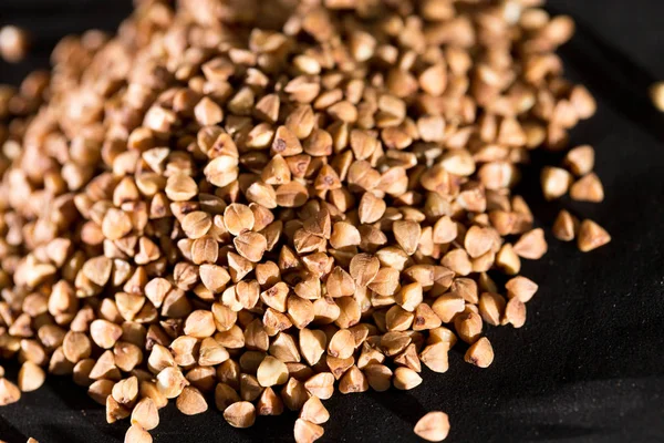 Buckwheat on a black background — Stock Photo, Image