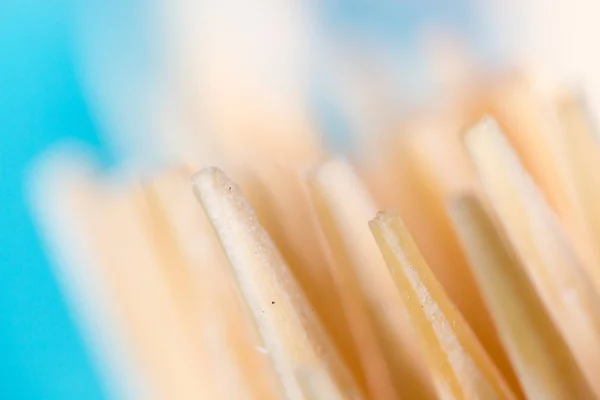 Toothpicks on a blue background. macro — Stock Photo, Image