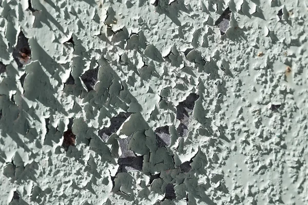 Old cracked paint on a wall as a background — Stock Photo, Image