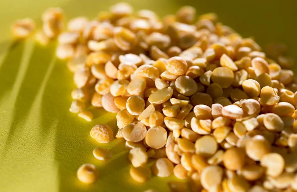 Yellow peas on a yellow background — Stock Photo, Image