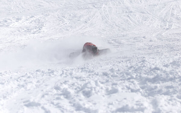 People fell on a snowboard in the snow in the winter