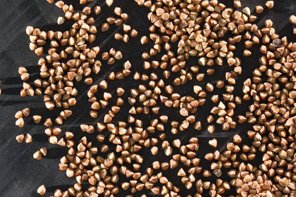 Buckwheat on a black background — Stock Photo, Image