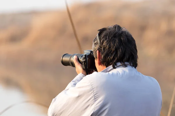 Uomo fotografa il lago — Foto Stock