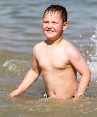 Oğlan gölde sahile doğru yıkandı.