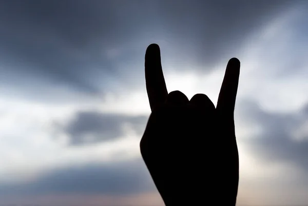 Silhouette of the hand on the sunset background — Stock Photo, Image