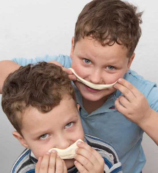 Two boys playing with dough — Stock Photo, Image