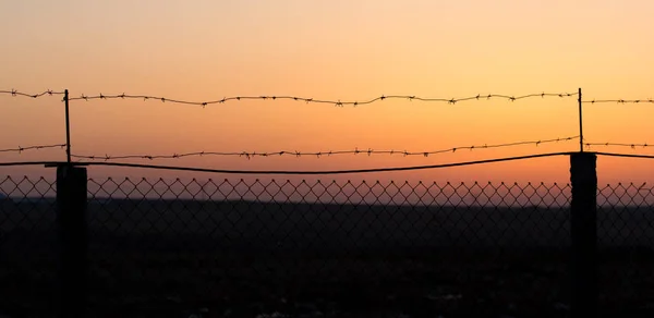 Fil barbelé au coucher du soleil — Photo