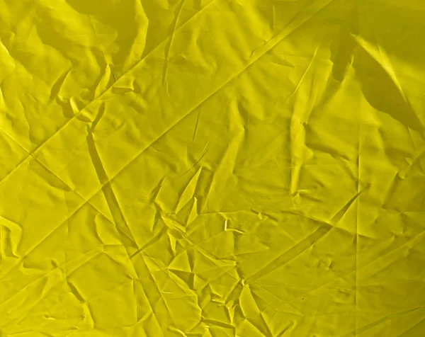 Pomarszczony żółte tkaniny jako tło — Zdjęcie stockowe