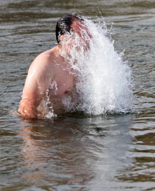 bir adam sudan atlar