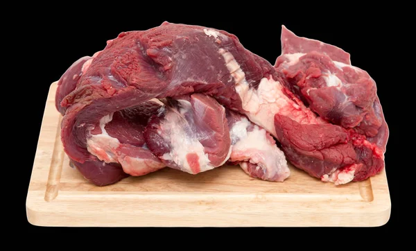 Fleisch auf dem Brett auf schwarzem Hintergrund — Stockfoto