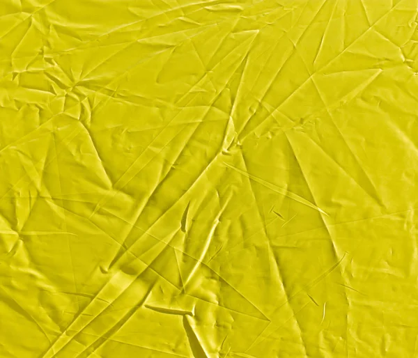 Arrugado paño amarillo como fondo —  Fotos de Stock