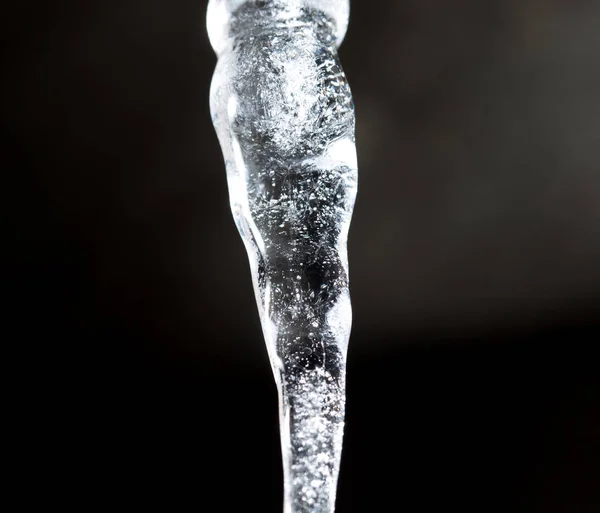 Icicle on a black background — Stock Photo, Image