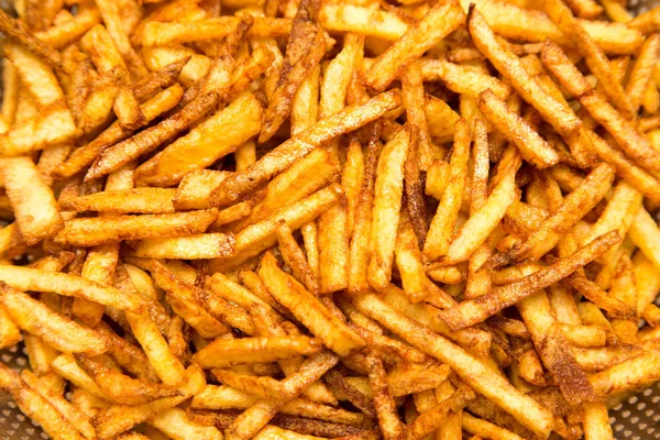 Cooking potato fries in oil — Stock Photo, Image