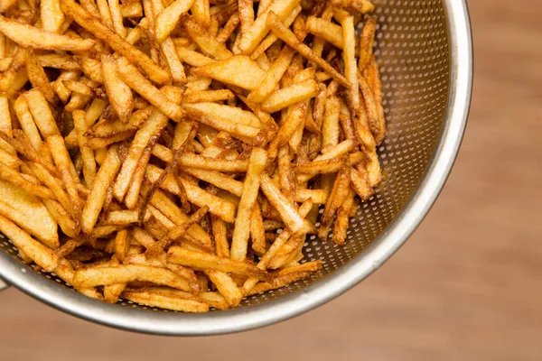 Cooking potato fries in oil — Stock Photo, Image