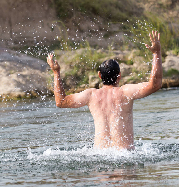 a man jumps out of the water