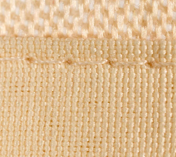 Filamento sul tessuto come sfondo. macro — Foto Stock