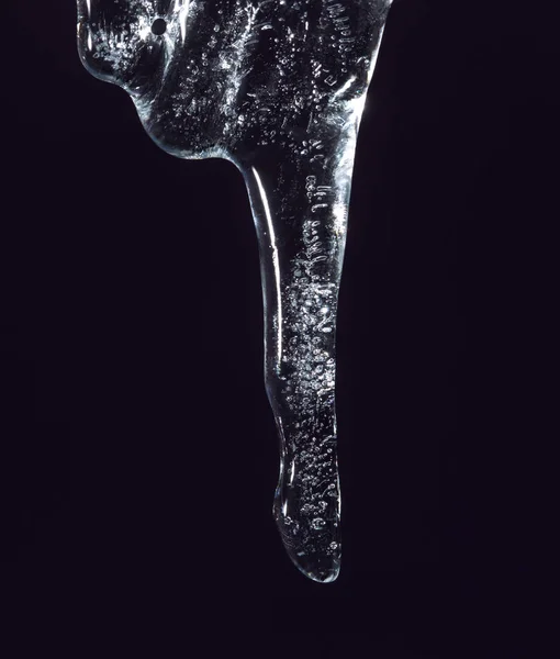 Icicle on a black background — Stock Photo, Image