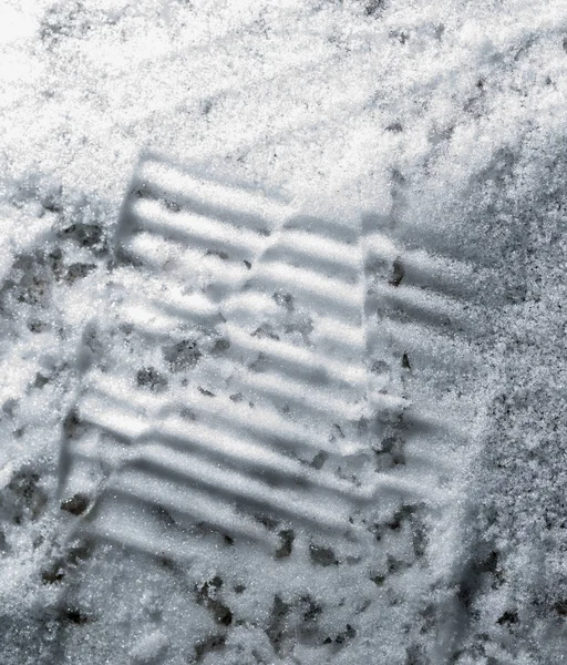 Trace of the shoe in the snow as a fone — стоковое фото