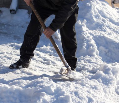 İşçi kar küreği temizler