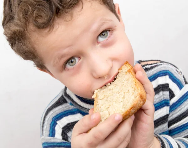 Pojken äter bröd — Stockfoto