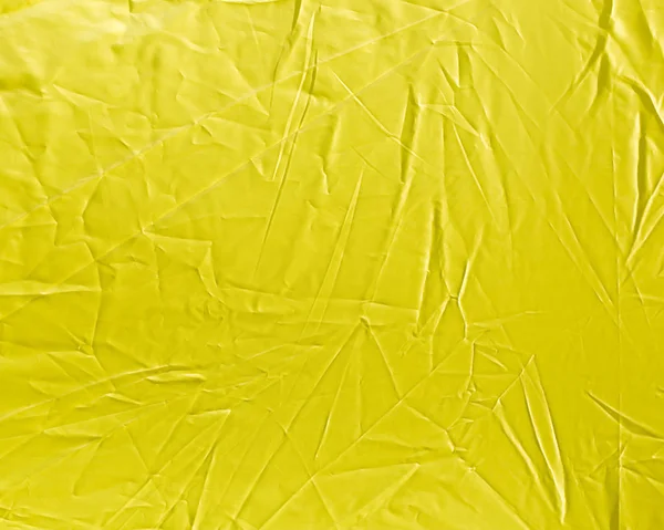 Pano amarelo enrugado como fundo — Fotografia de Stock
