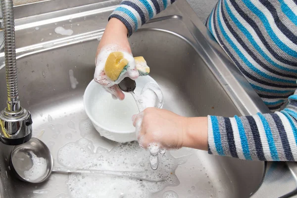 Jongen afwas in de keuken — Stockfoto