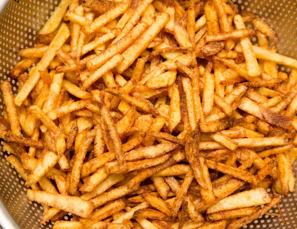 Cooking potato fries in oil — Stock Photo, Image