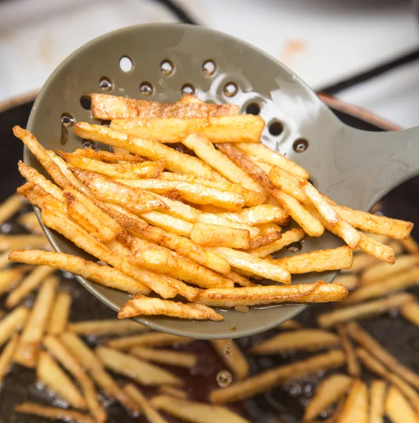 Cooking potato fries in oil — Stock Photo, Image