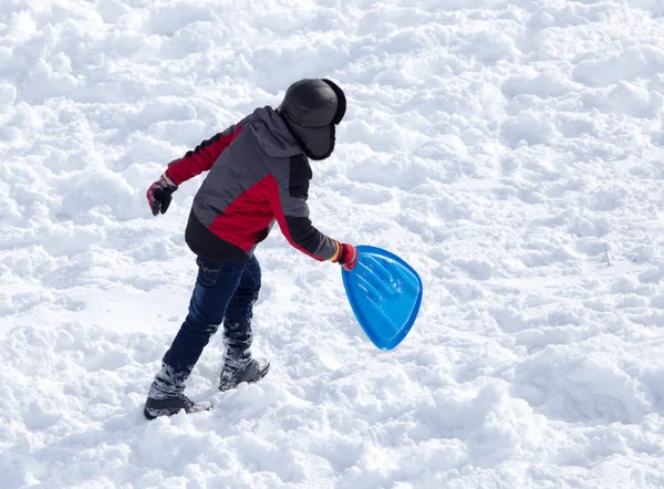 Enfant chevauchant un montagnes russes en hiver — Photo