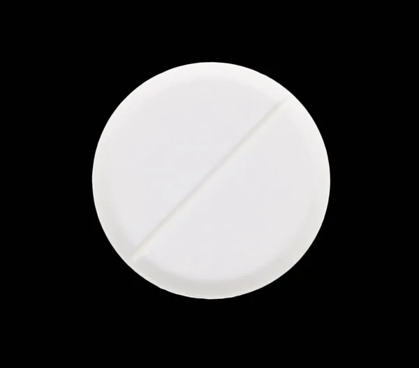 Tabletas médicas sobre fondo negro — Foto de Stock