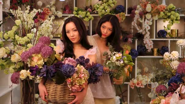 Virágkereskedések. Ázsiai nők boldog dolgozó virág bolt — Stock videók