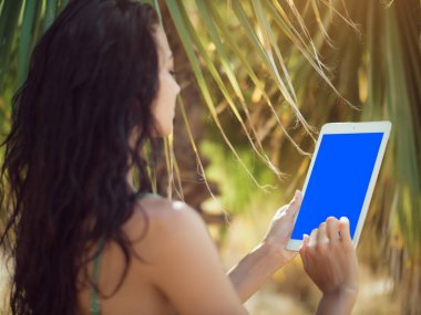 Tablet bilgisayar kullanan Gezgin kadın.