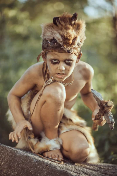 Caveman, manly boy with primitive weapon hunting outdoors. Ancient prehistoric warrior. Heroic movie look — Stock Image Caveman, manly boy with primitive weapon hunting outdoors. Ancient prehistoric warrior. Heroic movie look Stock Picture