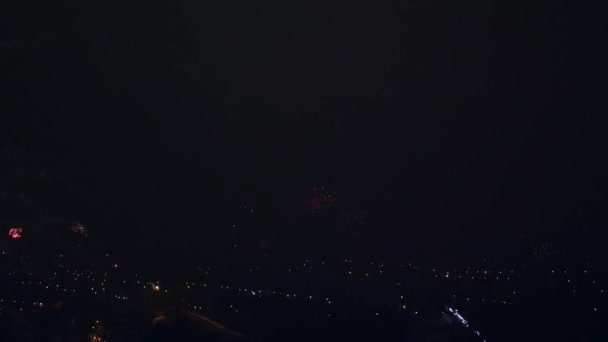 Fuegos artificiales sobre una ciudad nocturna en una celebración — Vídeos de Stock