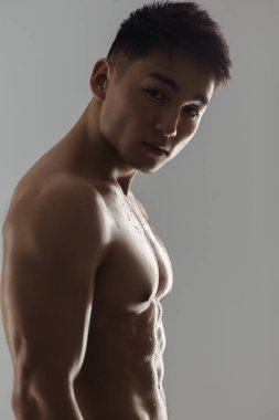 Portrait of Muscular Asian Man Indoors in Studio