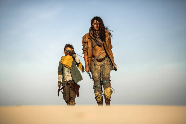 Post Apocalyptic Woman and Boy Outdoors in the Wasteland