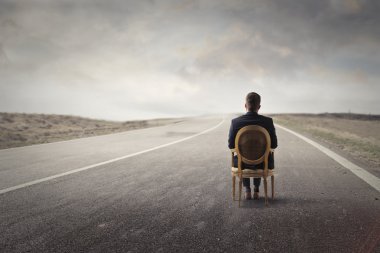 man in a chair on the road clipart